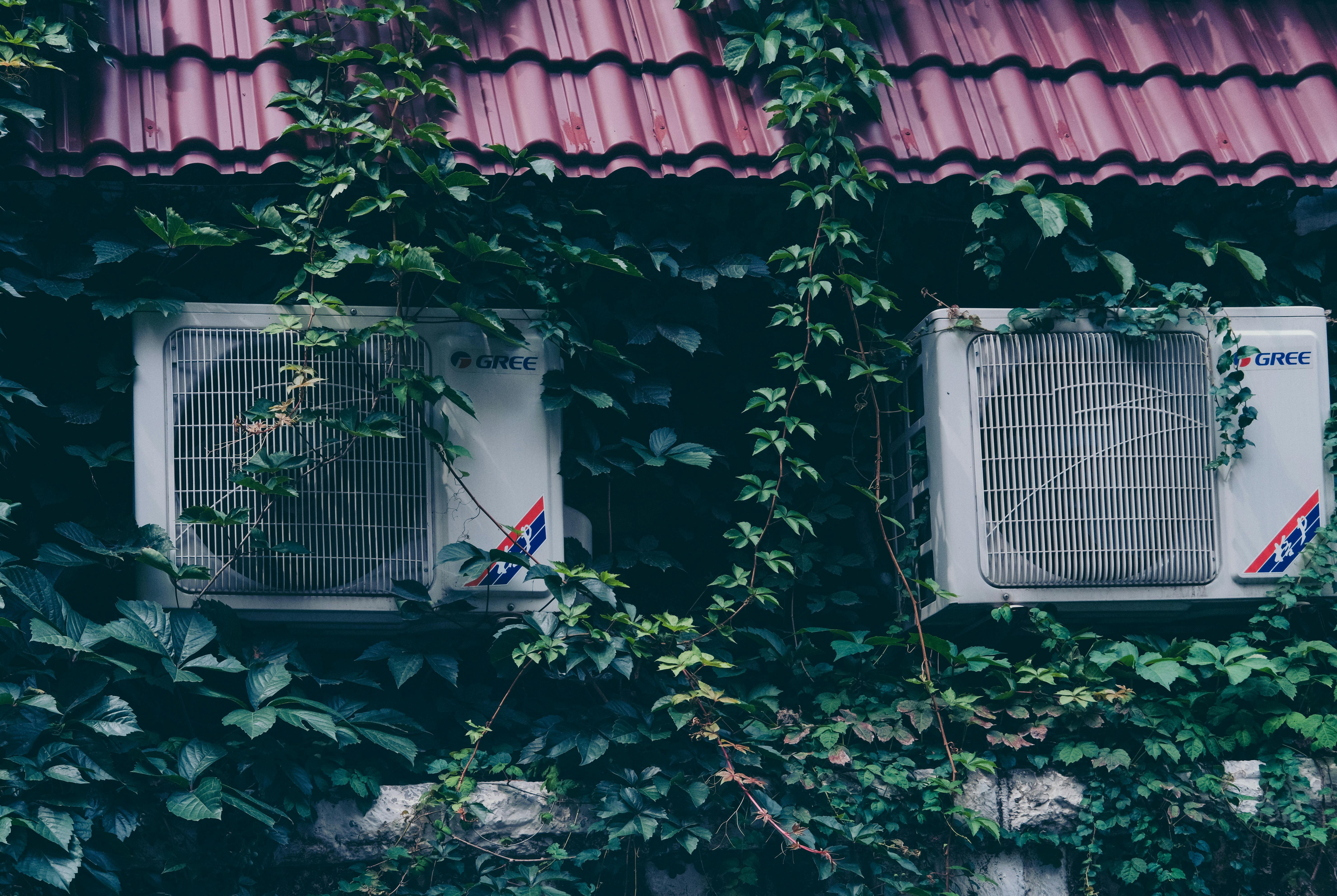 Air conditioning unit fitted above greenery